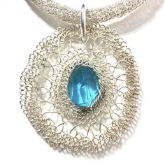 Sometimes you just want a pendant to go with your own chain, cord or ribbon!  This hand-made, woven flower-shape is made from sterling silver and upcycled glass. Despite its bold size, it remains light and delicate in nature. Wear it to a formal gathering or on a plain white t-shirt with jeans.  The sturdy jump ring is hand made from 12-gauge sterling silver wire with an inside circumference of 1/2 inch. Viking Knit chain (in photo) not included. CARE I recommend using a jewelers brass brush and Silver Glass Flower Pendant Jewelry, Unique Silver Glass Jewelry, Handmade Silver Plated Wire Round Pendant Jewelry, Handmade Silver Plated Round Pendant Jewelry, Handmade Silver Plated Round Pendant, Oval Silver Glass Jewelry, Oval Glass Silver Jewelry, Unique Blue Flower Pendant Jewelry, Phthalo Blue