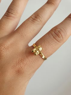 "GUMMY BEAR RING You can get a stylish and cute look with this 90's inspired teddy bear gold plated ring. It can be a gift suggestion that makes you or your loved ones realize the importance of your inner child. YOU MAY ALSO LIKE THESE: https://www.etsy.com/listing/956510530/18k-gold-plated-gummy-teddy-bear-cute https://www.etsy.com/listing/998626958/18k-gold-plated-rabbit-hugging-hands https://www.etsy.com/listing/982521278/18k-gold-plated-butterfly-animal-dainty HOW TO ORDER FROM US ? 1. Click on \"View cart and check out\" 2. At checkout, please fill in your special requests, check if the order is a gift. 3. Choose your shipping method. 4. Enter your payment details and complete purchase. MAINTENANCE OF YOUR JEWELRY - Maintain your jewelry's high shine by avoiding contact with any chemi Teddy Bear Ring, Bear Ring, Style Année 90, Gift Suggestions, Thumb Ring, Gummy Bear, Boho Ring, Cute Rings, Best Friend Gift