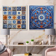 two blue and orange tiles on the wall in a living room with pink chairs, coffee table and lamp