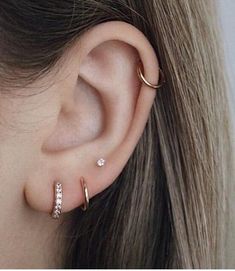 a woman's ear with two different types of piercings