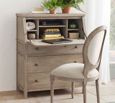 a desk with a chair next to it and a potted plant on top