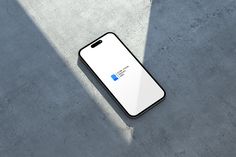 an iphone case sitting on the ground next to a concrete floor with a blue and white logo