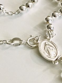 "MIRACULOUS VIRGEN 925 STERLING SILVER ITALIAN ROSARY 20\" LONG . FOR PROTECTION AND GOOD LUCK , WEDDING, COMMUNION. MADE IN ITALY 5 MM BEADS GR: 23 gr ROSARIO DE PLATA ESTERLINA DE LA VIRGEN DE LA MILAGROSA 925 SILVER, 20\" LARGO . PARA PROTECCION Y BUENA SUERTE . HECHO EN ITALIA 5 MM BEADS GR: 23 gr" Silver Necklace With Miraculous Medal For Jewelry Making, Silver Miraculous Medal Necklace With Round Beads, Spiritual Silver Rosary Bracelet With Charms, Silver Round Rosary For Spiritual Use, Silver Spiritual Rosary, Spiritual Sterling Silver Rosary Bracelet, Spiritual Engraved Silver Rosary Bracelet, Silver Rosary With Miraculous Medal And Round Beads, Spiritual Sterling Silver Rosary In Silver