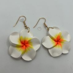 two white and yellow flower shaped earrings