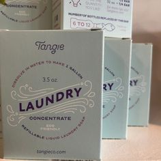 four boxes of laundry soap sitting on top of a table