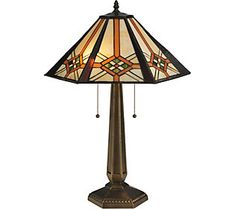 a table lamp with a stained glass shade on it's base and an ornate design