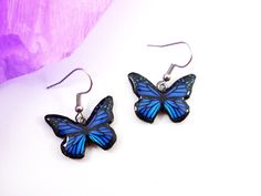 "Butterfly earrings is hand formed out of black polymer clay, printed picture and finished with resin. A wonderful gift for yourself or a friend! Size:  Butterfly width 0.98\"  / ~2.5 cm  drop lenght: ~~1.18\" / ~3 cm *It will come nicely gift wrapped. *Please note: real colors may differ slightly from their appearance on your display. If you have any question, please feel free to contact with me. ❖︎❖︎❖︎❖︎❖︎ Please check out other my jewelry. Thank You so much. :)  https://www.etsy.com/shop/Jewe Blue Butterfly Jewelry With Butterfly Print, Blue Butterfly Print Jewelry As A Gift, Blue Butterfly Print Jewelry For Gifts, Blue Jewelry With Butterfly Print For Gift, Blue Butterfly Charm Earrings For Gift, Handmade Blue Butterfly Earrings, Blue Butterfly Earrings Gift, Blue Butterfly Earrings For Gift, Blue Butterfly Earrings As Gift