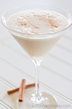 a drink in a martini glass with cinnamon on the rim