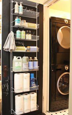 a washer and dryer sitting next to each other in a room with black walls