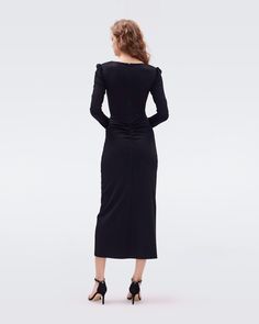 A classic little black dress, the Hughie midi is cut from a soft jersey. This piece has long sleeves, slightly puffed shoulders, a subtle sweetheart neckline, and flattering ruching that gathers at the hip. LENZING™ ECOVERO™ Viscose fibers are created from renewable wood sources and manufactured using less water and emitting less CO2. Better for the environment, better for your style.Yana is 5 Foot and 8 Inches and wearing a size XS. Long Sleeve Ruched Midi Dress For Dinner, Dinner Midi Dress With Gathered Sleeves, Elegant Dresses With Elastic Shoulders For Night Out, Elastane Midi Dress With Ruched Bodice For Night Out, Midi Dress With Ruched Bodice In Elastane, Elastane Midi Dress With Ruched Bodice, Elegant Long Sleeve Dress With Elastic Shoulders, Formal Midi Dress With Ruched Bodice, Fitted Midi Dress With Ruched Bodice For Fall