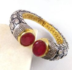 This Listing is for 1 Piece Beautiful Red Garnet & CZ Hydro Gemstone 24k Gold Plated Cuff Bangle Bracelet Jewelry Gemstone: Red Garnet & CZ Metal : Brass Style : Cuff Bracelet Size : Cuff Adjustable Size Plating : 24k Gold Plated & Black Oxidize Color : Yellow,White, Black Note : We Ship Parcel Via India Post Economy Shipping It's Take 20 To 25 Days To Arrive. Check my other items frequently. I will be adding to the inventory regularly. Be sure to visit my shop to check for any coupo Luxury Red Traditional Cuff Bracelet, Handmade Ruby Bangle Bracelet, Red Ruby Bangle As Gift, Jeweled Bangle Cuff Bracelet As Gift, Jeweled Cuff Bangle Bracelet For Gift, Red Jeweled Bangle As A Gift, Red Jeweled Bangle For Gift, Red Ruby Gemstone Bangle, Elegant Red Round Cuff Bracelet