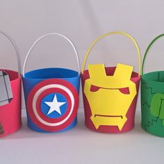 four paper bags with different designs on them, one has a hammer and the other has a shield