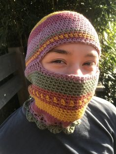 a person wearing a knitted hat and scarf