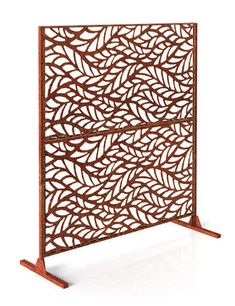 an intricately designed metal screen with wooden legs and feet, on a white background