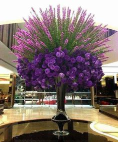 a vase filled with purple flowers on top of a table