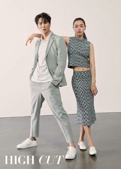 two people standing next to each other in front of a white wall with the words high cut on it