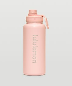 a pink water bottle sitting on top of a white table