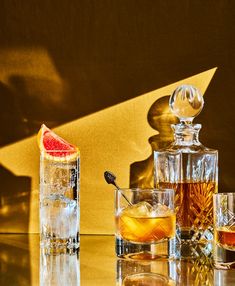 an assortment of liquors and glasses on a table