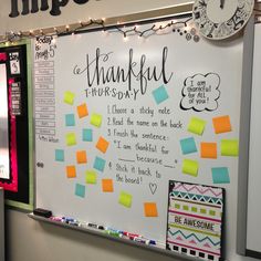 a bulletin board with post it notes attached to it and a clock hanging on the wall