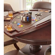 a wooden table with two chairs and a game set on it, in front of a window