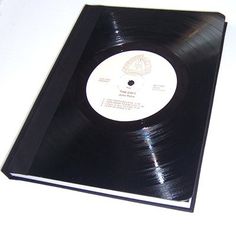 a black vinyl album with white writing on it