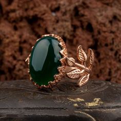 Green Aqeeq Flower Rose Gold Plated Silver Women Ring. Handmade in 925 gold color plating sterling silver with agate stone. On the ring Oval Green Aqeeq - Agate stone settled. At sides, flower figure settled with micro detailed ornament. Dimensions of stone is 20 mm x 15 mm. Average weight of Green Aqeeq Flower Rose Gold Plated Silver Women Ring is 9 gr. (depends on your ring size). Back side is open and stone touches your skin. Classic and exclusive style. Stone Type: Aqeeq - Agate Stone Color: Luxury Agate Wedding Jewelry, Elegant Chalcedony Jewelry With Polished Finish, Jade Jewelry With Polished Finish For Anniversary, Elegant Agate Jewelry For Anniversary, Anniversary Jewelry In Polished Jade, Anniversary Jade Jewelry With Polished Finish, Anniversary Jade Jewelry, Nature-inspired Cabochon Jewelry For Anniversary, Nature-inspired Rose Gold Gemstone Jewelry