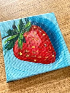 a painting of a red strawberry on a blue background