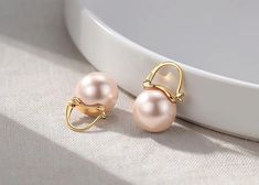 *Metal Type: sterling silver 18K Gold Plated *Earring dimension:22 *Gemstone:Synthetic pearl  *Pearl dimension:12mm-14mm *Quantity:one pair earrings *Sterling Silver Pearl Ear Huggie Hoops,Pink Pearl Hoop Earrings,12mm,14mm Pearl Earrings,Bridesmaid Earrings,Elegant Gift for Mom Description The pearl conch ear cuff  made of 925 sterling silver, a 100% handmade item ,this ear cuff earrings makes a great minimalist , perfect for engagement, wedding, anniversary, every day, or any special occasion. Perfectly gift for the girl friend, wife, bridesmaid, bride,Anniversary ,etc. It is perfect for all ages, and as a gift ,wedding ,Birthday gift,Christmas gift,Thanksgiving gift PACKAGING All items comes in a special gift box. SHIPPING AND MAKING TIME *The items  will be made within 3-7business  fro Formal Pink Round Clip-on Earrings, Pink Round Hoop Earrings For Formal Occasions, Pink Round Hoop Earrings For Formal Events, Pink Elegant Clip-on Earrings For Anniversary, Elegant Pink Clip-on Earrings For Anniversary, Elegant Hypoallergenic Pink Gold Earrings, Elegant Pink Hoop Earrings For Weddings, Bridesmaid Pearl Earrings, Mom Wedding