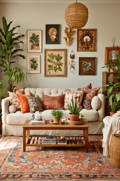 a living room filled with lots of plants and pictures on the wall above it's couch