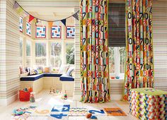 a brightly colored room with colorful curtains and pillows