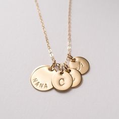 "Gold filled Nana necklace personalized with initials. A sweet and simple gift for grandma, that she will truly cherish. Personalized with grandchildren's initials. Dainty, timeless, perfect for every day. FEATURES: * high-quality gold filled discs are hand finished, * the large disc is carefully hand stamped with the word \"NANA\", * small discs will be stamped with initials of your choice, * delicate gold filled chain is finished with a spring clasp closure. MEASUREMENTS: * 14K gold filled lar Classic Customizable Necklaces For Birthdays, Customizable Classic Necklace For Birthday, Classic Customizable Necklace For Birthday, Customizable Everyday Necklaces With Initial Pendant, Customizable Everyday Initial Pendant Necklace, Customizable Initial Pendant Necklace For Everyday, Custom Name Initial Pendant Charm Necklace For Mom, Classic Hand Stamped Necklaces For Anniversary, Everyday Personalized Initial Pendant Necklace