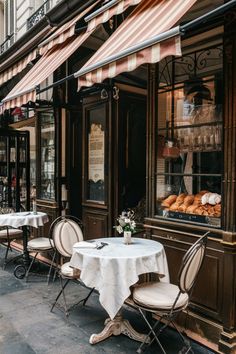 an outdoor cafe with tables and chairs outside