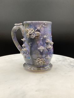 a blue and white mug sitting on top of a table