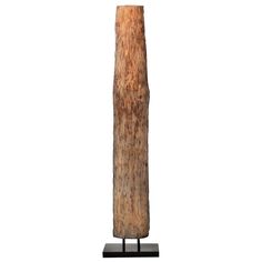 a tall wooden object on a black stand