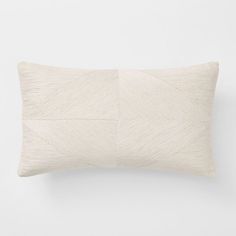 a white pillow with an arrow design on the front and back, against a white background