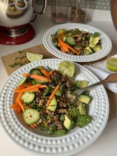 two white plates filled with salad on top of a counter