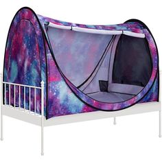 a bed with a purple and blue tent on it's headboard, in front of a white background