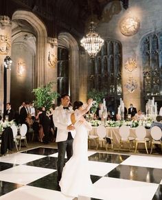 a bride and groom dancing on the dance floor at their wedding reception in an elegant ballroom