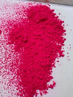 a pile of pink powder sitting on top of a white table