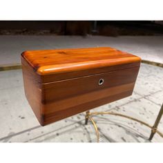 a wooden box sitting on top of a glass table