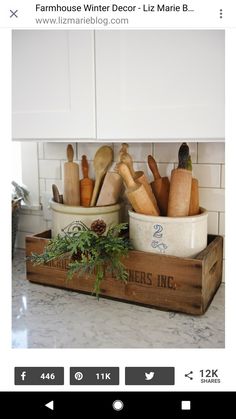 a kitchen counter with pots and pans on top of it in a wooden box