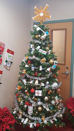 a decorated christmas tree in front of a door