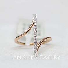 a gold ring with two rows of diamonds in the middle and an open band on top