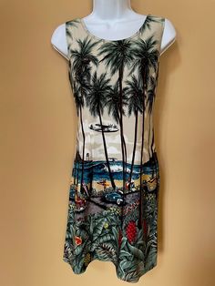 "Authentic vintage Hawaiian Reserve Collection brand dress, made in Hawaii, women's size medium. 100% rayon. Cool retro surf scene on the dress with airplane, whale, lighthouse, surfers, palm trees and flowers- almost as good as being there in person! Perfect vintage condition. This dress us super unique and tons of fun. Freshly dry cleaned, pressed and ready to wear now! All measurement taken with the garment laid flat 35.5\" shoulder to hem 17\" pit to pit 16\" waist" Vintage Printed Dress For Vacation, Vintage Dress With Tropical Print For The Beach, Vintage Printed Beach Dress, Vintage Tropical Print Dresses For Vacation, Retro Tropical Print Dress For Vacation, Vintage Tropical Print Dress For Vacation, Vintage Tropical Print Beach Dress, Vintage Beach Dress With Tropical Print, Retro Tropical Print Vacation Dress