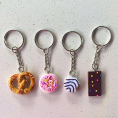 four different types of donuts are shown on a white surface with sprinkles