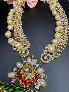 This elegant and gorgeous Rajasthani style necklace comes with matching earrings and is sure to be a hit for any event! The bright colors can match any outfit and the colors are gorgeous shades with a beautiful finish. It‰۪s such an elegant wear for any event and can be dressed up in so many ways. The pastel mixed with darker hues in meenakari work is so beautiful and light to wear. Fusion Style Chandbali Necklace For Celebration, Elegant Multicolor Necklace For Festive Season, Chandbali Fusion Necklace For Celebration, Elegant Multicolor Kundan Necklace, Elegant Multicolor Necklace For Festivals, Elegant Multicolor Necklaces For Festivals, Elegant Multicolor Meenakari Necklace, Kundan Long Necklace For Party, Fusion Style Long Necklace For Wedding