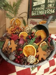 a metal pan filled with orange slices and other decorations