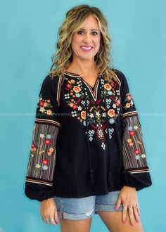 STARRY EYED FOR THIS EMBROIDERED CUTIE! Black with Multicolored Floral Embroidery Keyhole Neckline w/ Ties | Full-length Sleeves w/ Elastic Wrist | Split Hemline Woven | No Stretch | Fits True To Size Main: 100% Contrast: 50% Cotton 50% Polyester Measurements Bust Measured Laid Flat Across Front | Armpit to Armpit S 20” | M 21” | L 22” | 1XL 25” | 2XL 26” | 3XL 17” Length Measured Shoulder to Hemline S 25” | M 26” | L 26” | 1XL 27” | 2XL 28” | 3XL 28” Model: Holly is wearing a Small, Carolyn is Western Dress, Starry Eyed, Stars Hollow, Keyhole Neckline, Western Dresses, Sewing Tips, Black Star, Sewing Hacks, Floral Embroidery