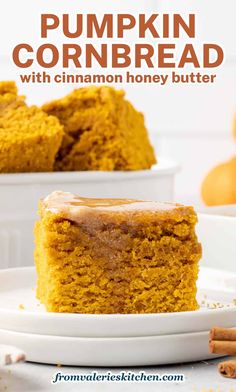 a slice of pumpkin cornbread with cinnamon honey butter is on a white plate and the rest of the cake is in the background