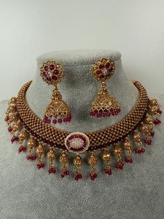 This exquisite piece of craftsmanship comes from our Traditional collection. Finish: 24 grams gold finish Necklace Fastening: Adjustable Dori  Perfect for Indian weddings. Earring jhumka Fastening: Push Back Contains: 1 necklace, 1 pair of earrings Luxury Temple Necklace For Diwali, Luxury Temple Jewelry Chandbalis For Diwali, Luxury Temple Jewelry Danglers For Celebrations, Ceremonial Hand Set Gold Plated Bridal Necklace, Ceremonial Hand-set Gold Plated Bridal Necklace, Ceremonial Gold-plated Hand Set Bridal Necklace, Adjustable Gold Kundan Necklace With Latkans, Adjustable Gold Jewelry Sets For Celebration, Ornate Gold Plated Necklace For Wedding